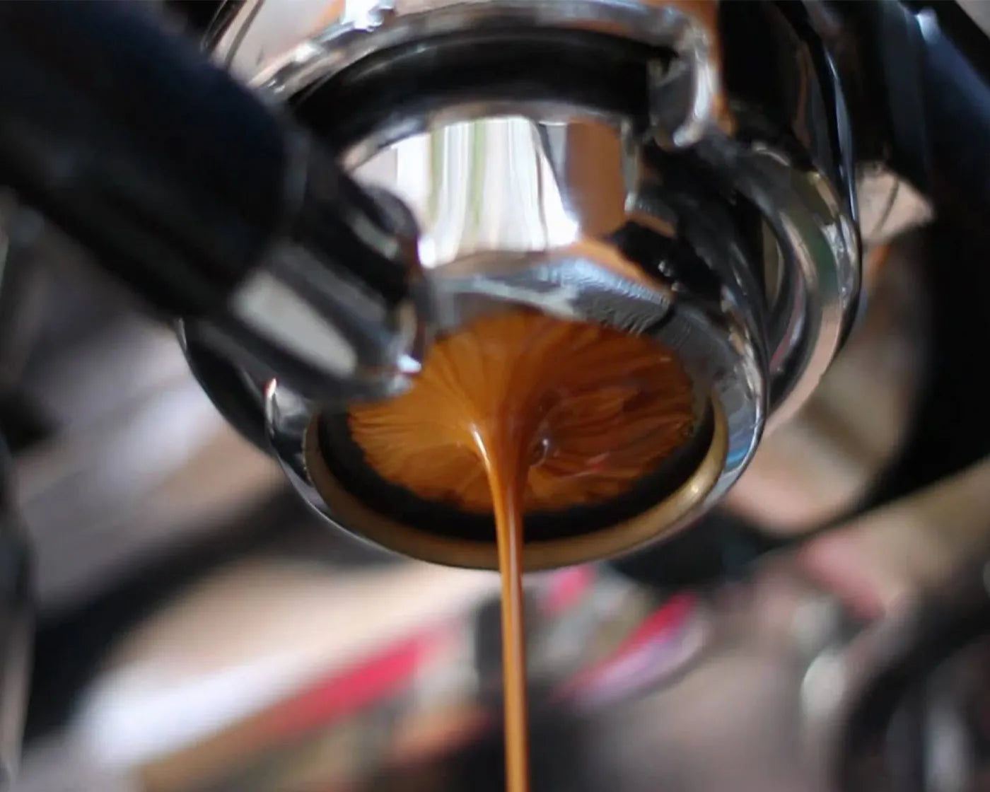 Close-up of rich espresso shot being brewed with perfect crema.
