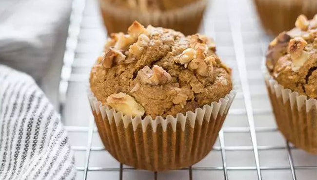 Homemade muffins with nuts on a cooling rack, fresh from the oven and ready to enjoy.