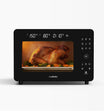 Ruokala air fryer perfectly roasting a chicken with a digital touchscreen interface for easy temperature and timer adjustments.
